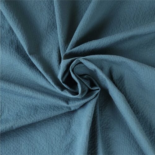 Tombé naturel du tissu seersucker bleu pétrole