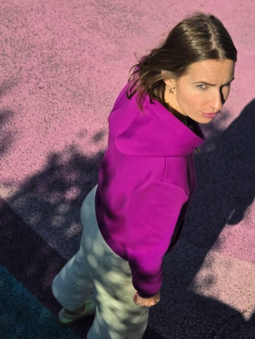 Vue de profil d’un hoodie fuchsia porté par une femme ; patron couture sweat femme Bauhaus.